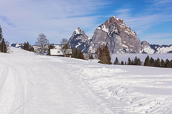 Snowy Ski Slope with Majestic Swiss Alps Mountain Peak