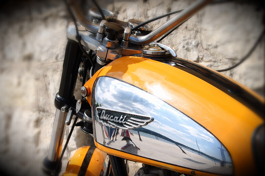 Close-up of vintage yellow Ducati motorcycle tank