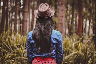 Woman in Fedora Hat Standing in Forest
