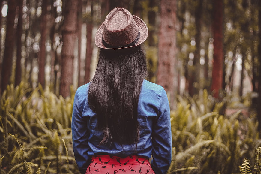 Woman in Fedora Hat Standing in Forest