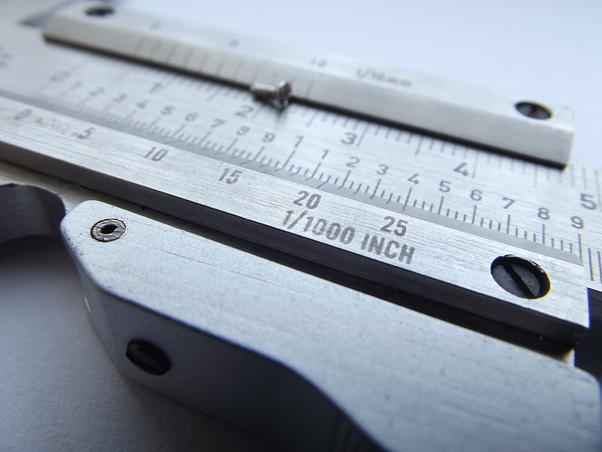 Close-up of metal vernier caliper with inch and millimeter scales