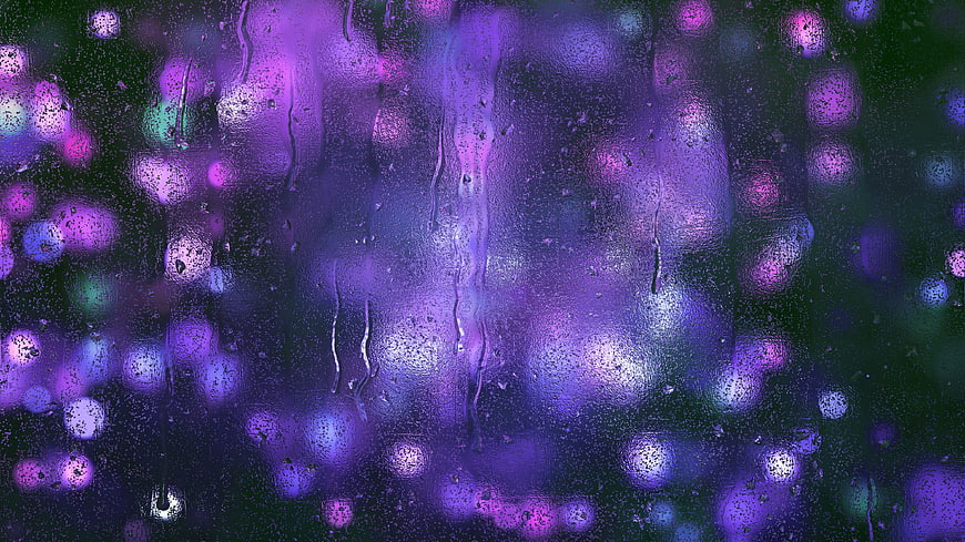 Abstract purple and blue bokeh lights on wet glass texture
