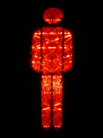 Red pedestrian traffic light symbol glowing on black background