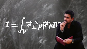 Professor thinking about physics formula on chalkboard