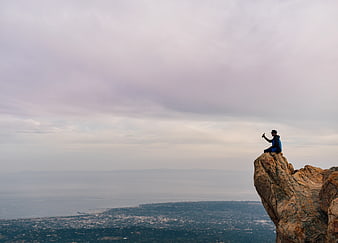 Man Taking Selfie on Rocky Mountain Peak Overlooking City