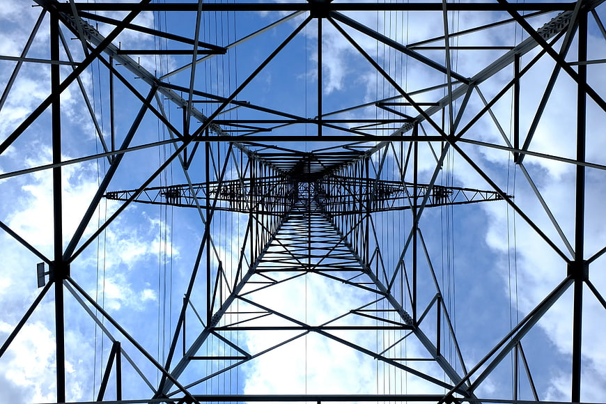 Low Angle View of Steel Electricity Pylon Against Blue Sky