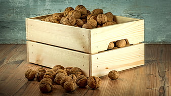 Wooden Crate of Walnuts on Rustic Table