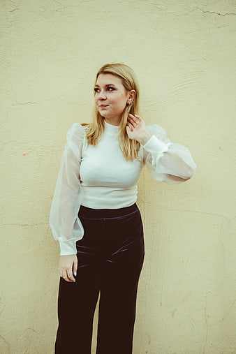 Blonde Woman in White Blouse and Black Velvet Pants