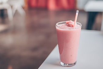 Pink Strawberry Smoothie in Glass with Straw
