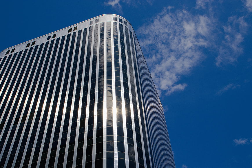 Modern Glass Skyscraper Against Blue Sky