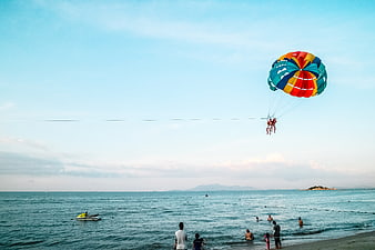 Colorful Parasailing Adventure Over Blue Ocean Beach