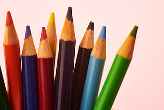 Close-up of colorful pencils on a pink background