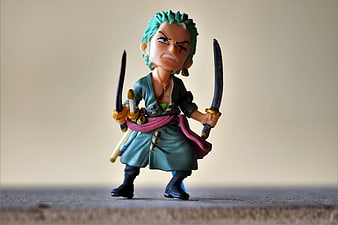 Green-haired anime swordsman figurine holding dual blades
