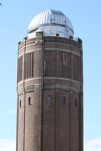Brick Observatory Tower with Silver Dome Against Blue Sky