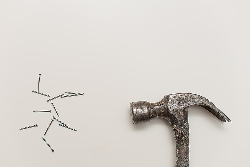 Vintage Hammer and Nails on White Background