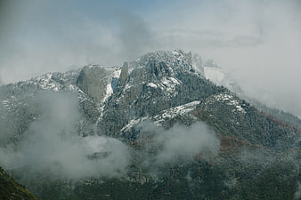 Majestic Snow-Capped Mountain Peak Shrouded in Mist