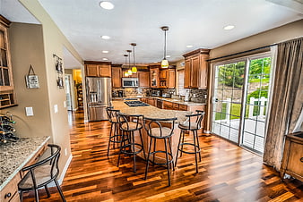Spacious kitchen with hardwood floors and granite island