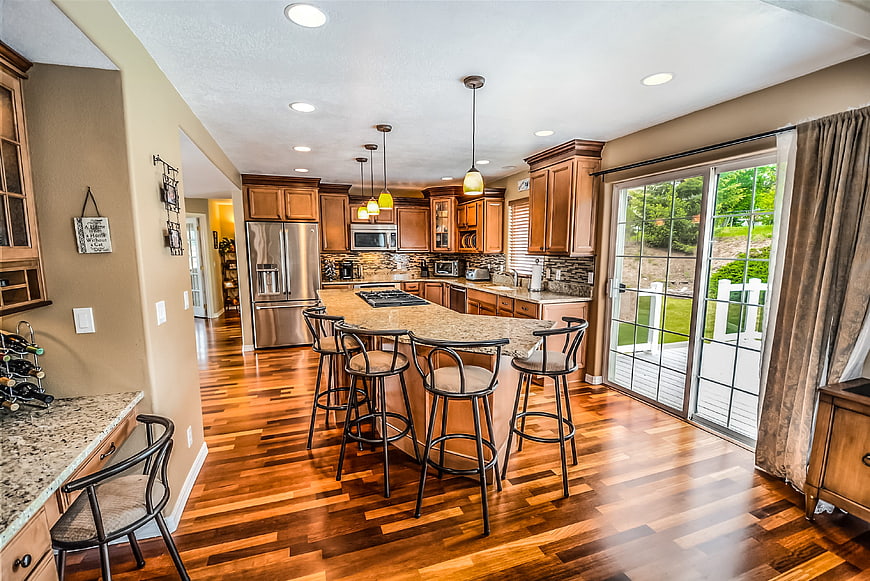 Spacious kitchen with hardwood floors and granite island