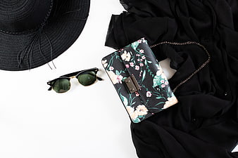 Summer fashion accessories flat lay with floral handbag and sunglasses