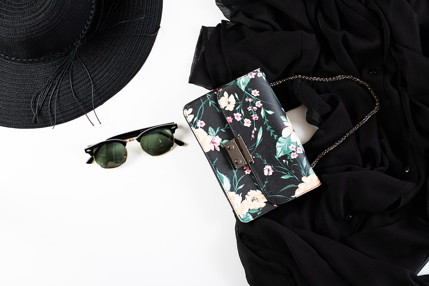 Summer fashion accessories flat lay with floral handbag and sunglasses