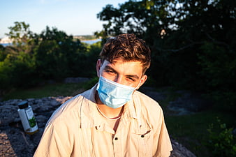 Young Man Wearing Blue Face Mask Outdoors