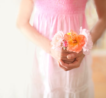 Woman in Pink Dress Holding Peach and Pink Flowers