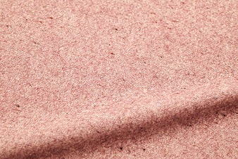 Close-up of textured pink fabric weave with natural fibers