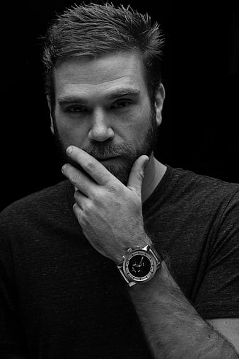 Black and white portrait of bearded man with watch