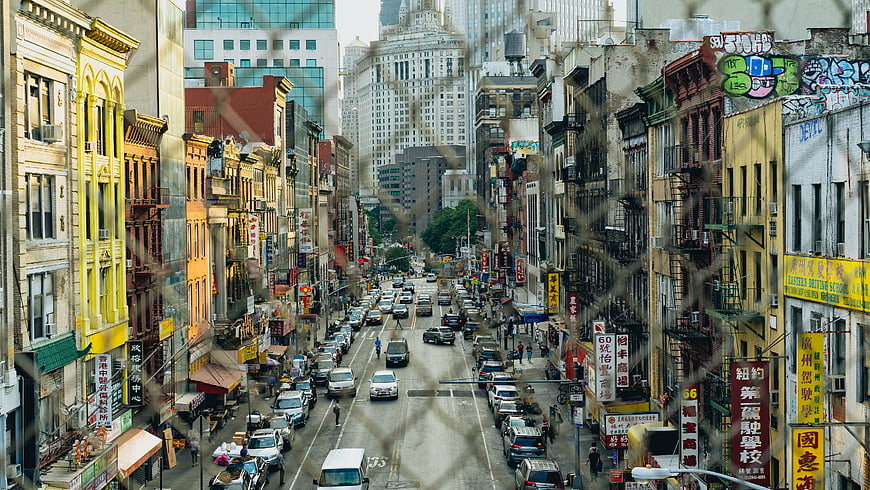 High Angle View of Chinatown Street Through Chain Link Fence