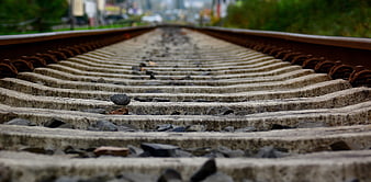 Low angle view of concrete railroad tracks stretching into distance