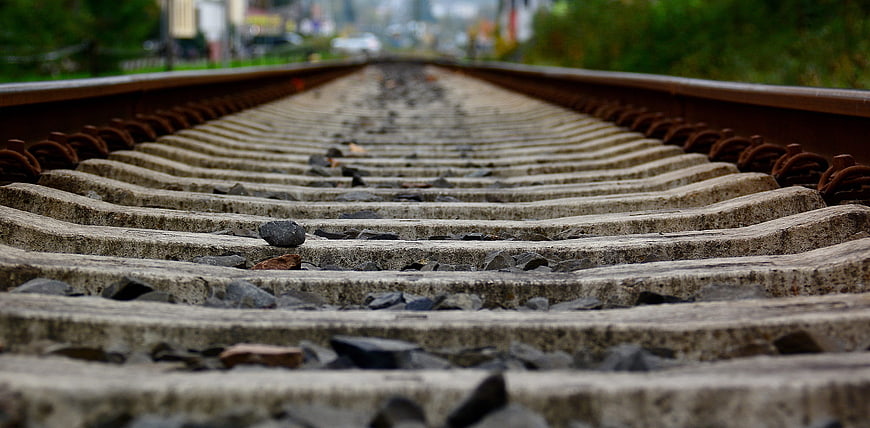 Low angle view of concrete railroad tracks stretching into distance