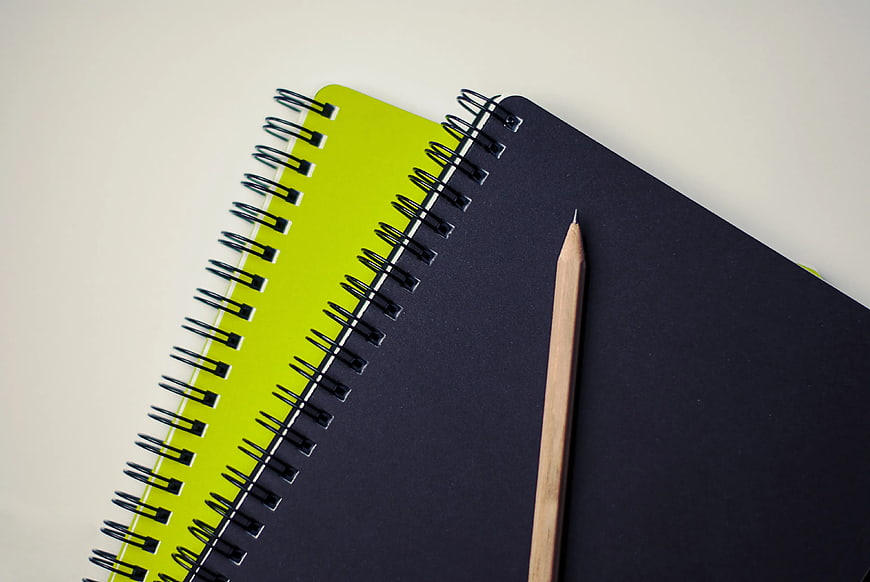 Minimalist Black Notebook and Pencil on Lime Green Pad