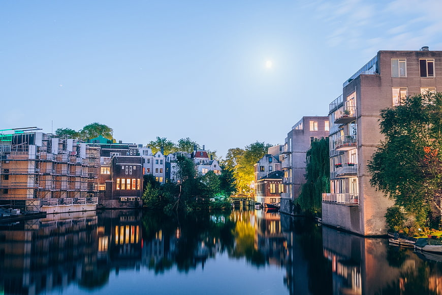 Serene Canal Reflections in Urban Neighborhood at Dusk