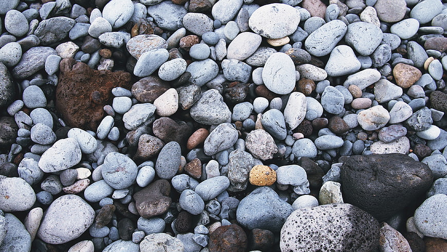 Close-up of smooth gray and brown pebbles on a beach
