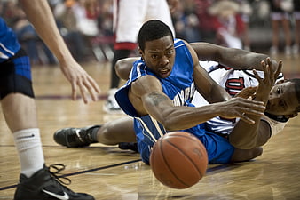 Intense Basketball Scramble For Loose Ball On Court