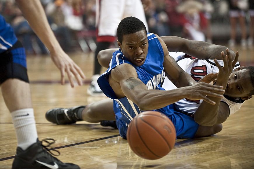 Intense Basketball Scramble For Loose Ball On Court