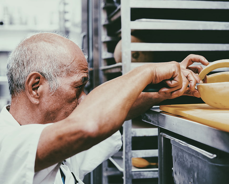 Senior Baker Preparing Dough in Professional Kitchen