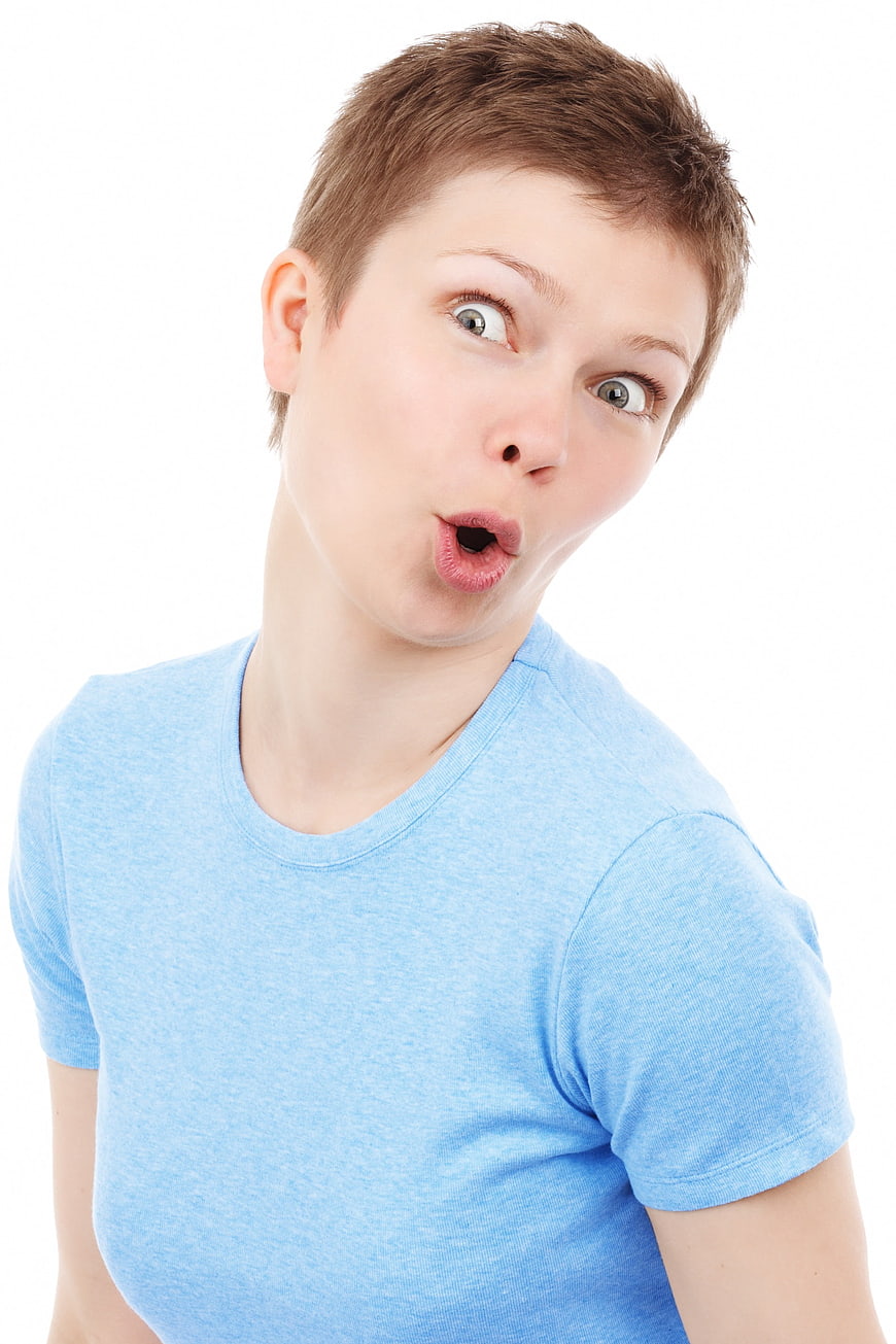 Surprised young woman with short hair on white background