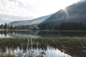 Serene Lake with Mountain Reflections and Sun Rays