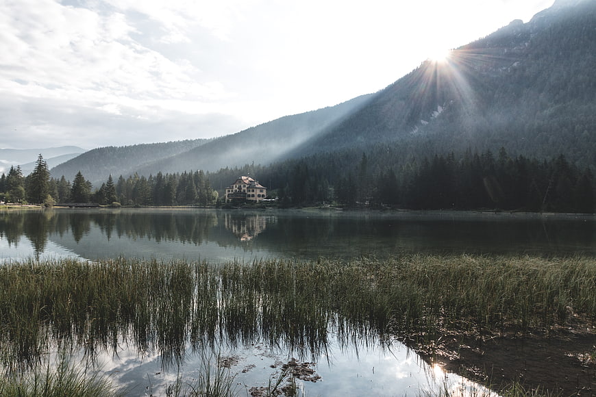 Serene Lake with Mountain Reflections and Sun Rays