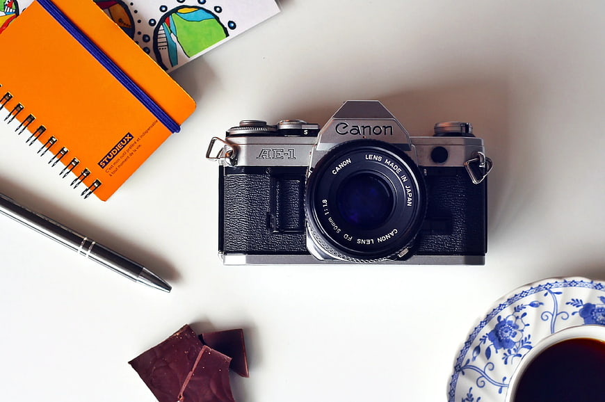 Vintage Canon AE-1 Camera Flat Lay with Coffee and Notebook