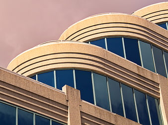 Modern curved office building architecture with blue glass windows