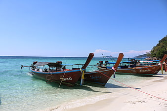 Traditional Thai Longtail Boats Anchored on Tropical Beach