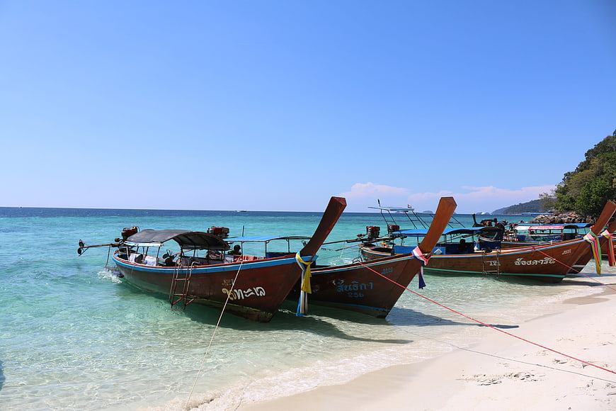 Traditional Thai Longtail Boats Anchored on Tropical Beach