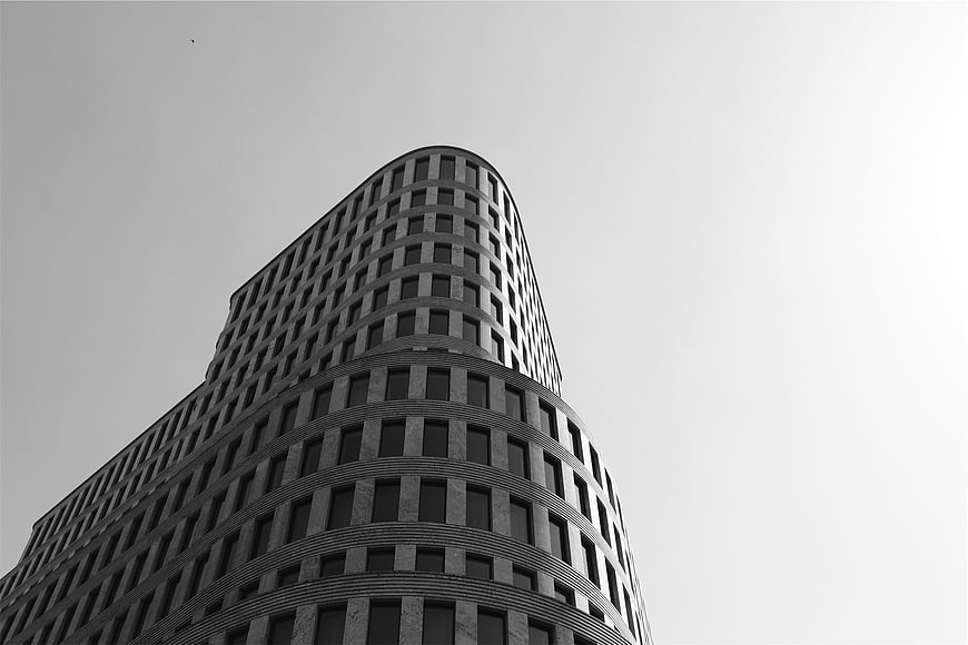 Low angle black and white modern curved office building