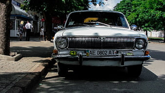 Front view of classic white Soviet car parked on street
