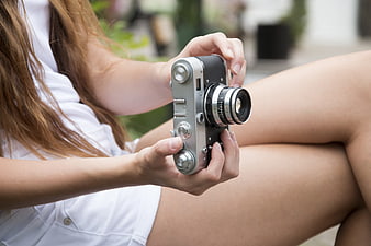 Woman Holding Vintage Retro Film Camera Outdoors