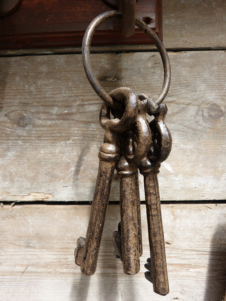 Vintage Rusty Iron Keys on Wooden Door