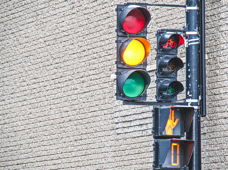 Urban Traffic Light Signal with Brick Wall Background