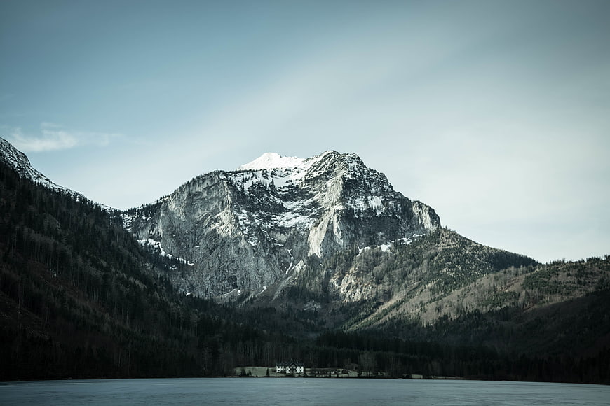 Snow-Capped Mountain Peak Overlooking a Serene Lake